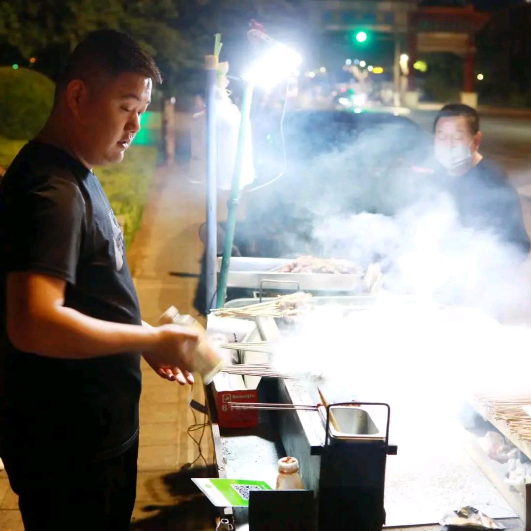 烤羊肉串的小男孩